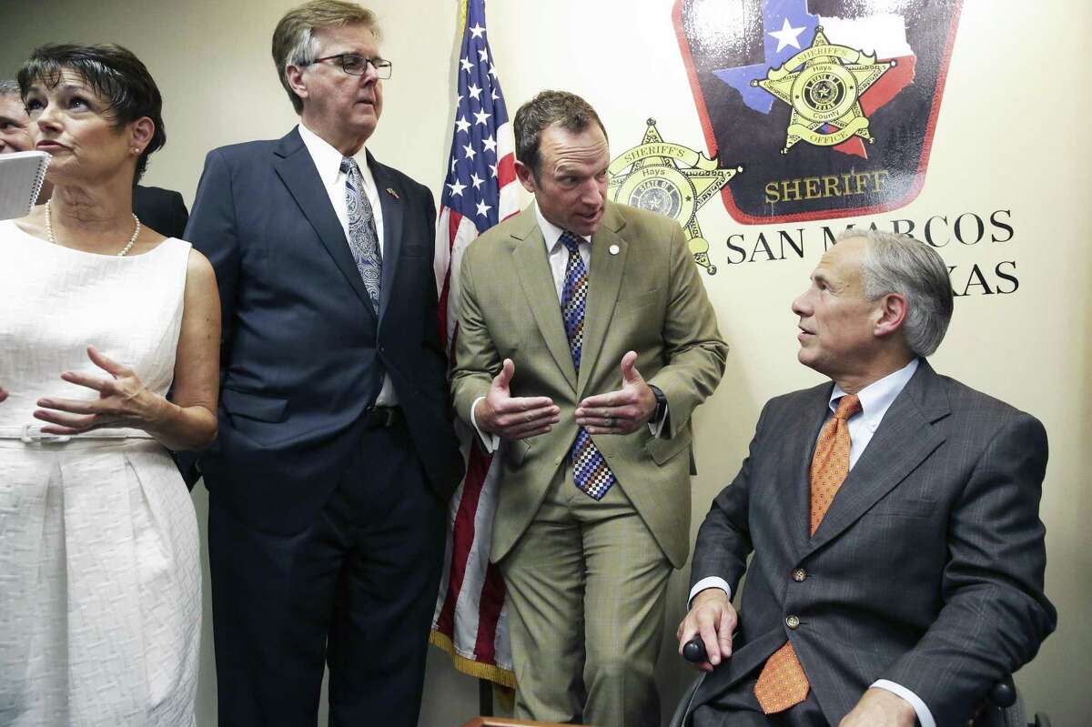 Gov. Greg Abbott discusses plans with Sen. Donna Campbell, R-New Braunfels; Lt. Gov. Dan Patrick and Rep. Jason Isaac, R-Blanco, after he reveals his school safety proposals at a Wednesday news conference at the Hays County Law Enforcement Center in San Marcos. He also presented his plan earlier in the day at Dallas. .