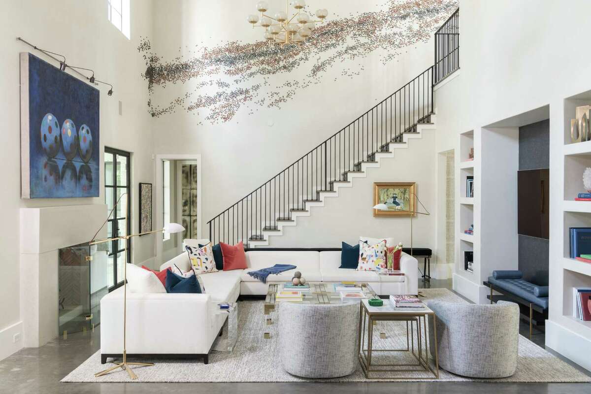 A Paul Fleming art installation runs up the staircase wall off of the family room of the Oak Estates home of Josh and Lisa Oren. Their home was designed by Laura Umansky of Laura U Interior Design.
