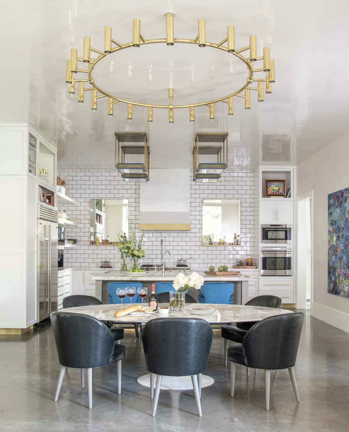 The Orens' home is filled with dramatic lighting, including these gold fixtures in the dining area and kitchen. Gold has been a big trend in lighting and in interior design in 2018.