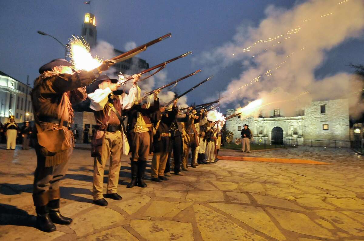 Re-enactors and descendants of the Alamo fire musket volley during the annual Dawn at the Alamo ceremony.
