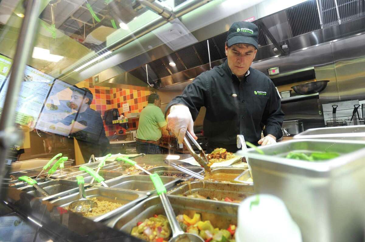 California Tortilla co-founder Keith Goldman stands on the line and makes a burrito in California Tortilla’s new restaurant at 300 Atlantic St., in downtown Stamford, Conn., on Wednesday, May 30, 2018.