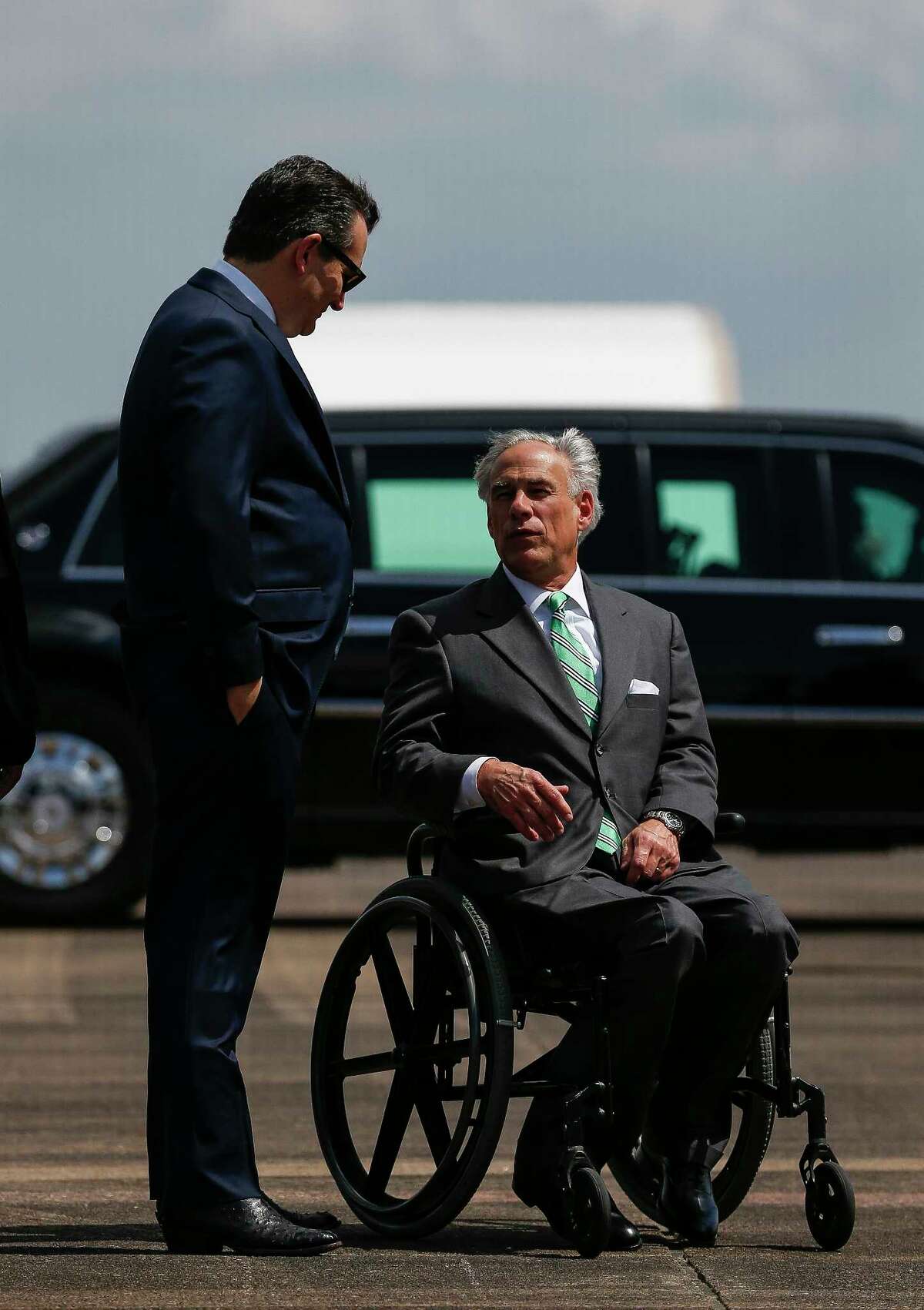 Senator Ted Cruz speaks with Governor Greg Abbott as President Donald Trump lands at Ellington Field Joint Reserve Base before meeting with those affected by the Santa Fe High School Shooting Thursday, May 31, 2018 in Houston.