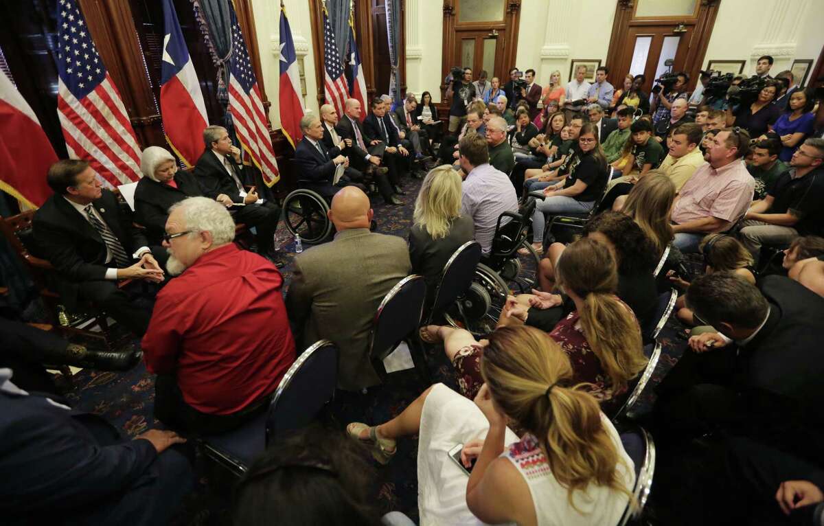 Texas Gov. Gregg Abbott, center in wheelchair, hosts a roundtable discussion to address safety and security at Texas schools in the wake of the shooting at Sante Fe, in Austin, Texas, Thursday, May 24, 2018. Thursday's roundtable included victims, students, families and educators from the Santa Fe, Alpine and Sutherland Springs communities. (AP Photo/Eric Gay)