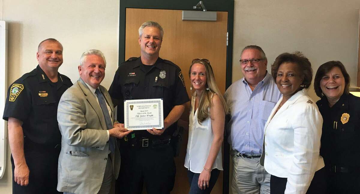 Norwalk's Officer of the Month Jamie Wright, center, holding certificate.