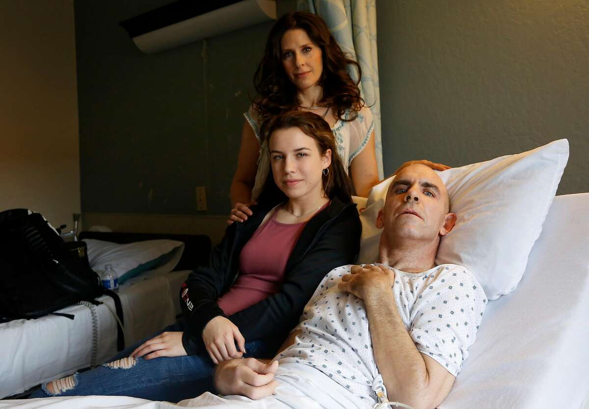 Bernie Dalton, who has been diagnosed with bulbar-onset ALS, with his daughter Nicole, 16, and voice coach Essence Goldman at Cupertino Healthcare & Wellness on Friday, February 2, 2018. After Dalton lost his voice, Goldman dedicated herself to bringing his song lyrics to life in the form of an album. A release party for that album will be held on Friday with proceeds supporting Dalton's end-of-life care.