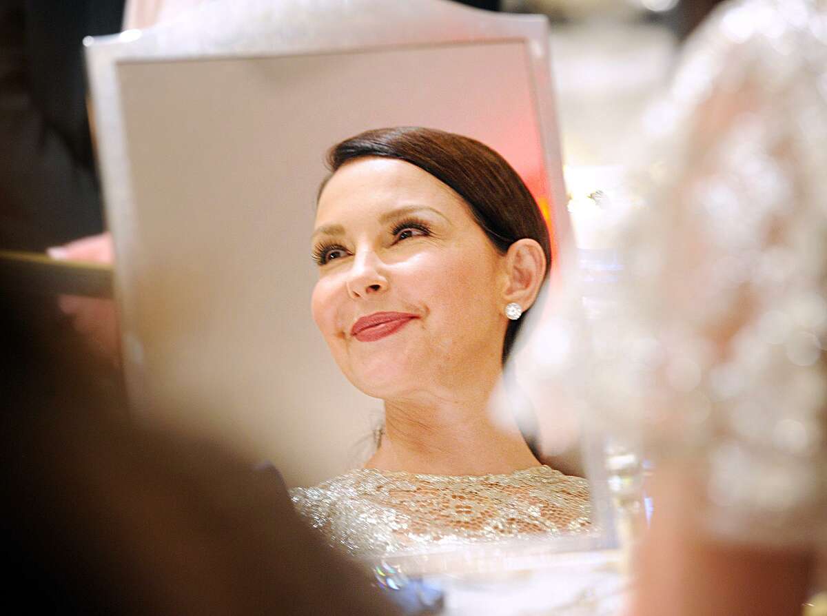 Ashley Judd smiles in a reflection in a jeweler's mirror during the Greenwich International Film Festival Changemaker Gala at Betteridge Jewelers Thursday.