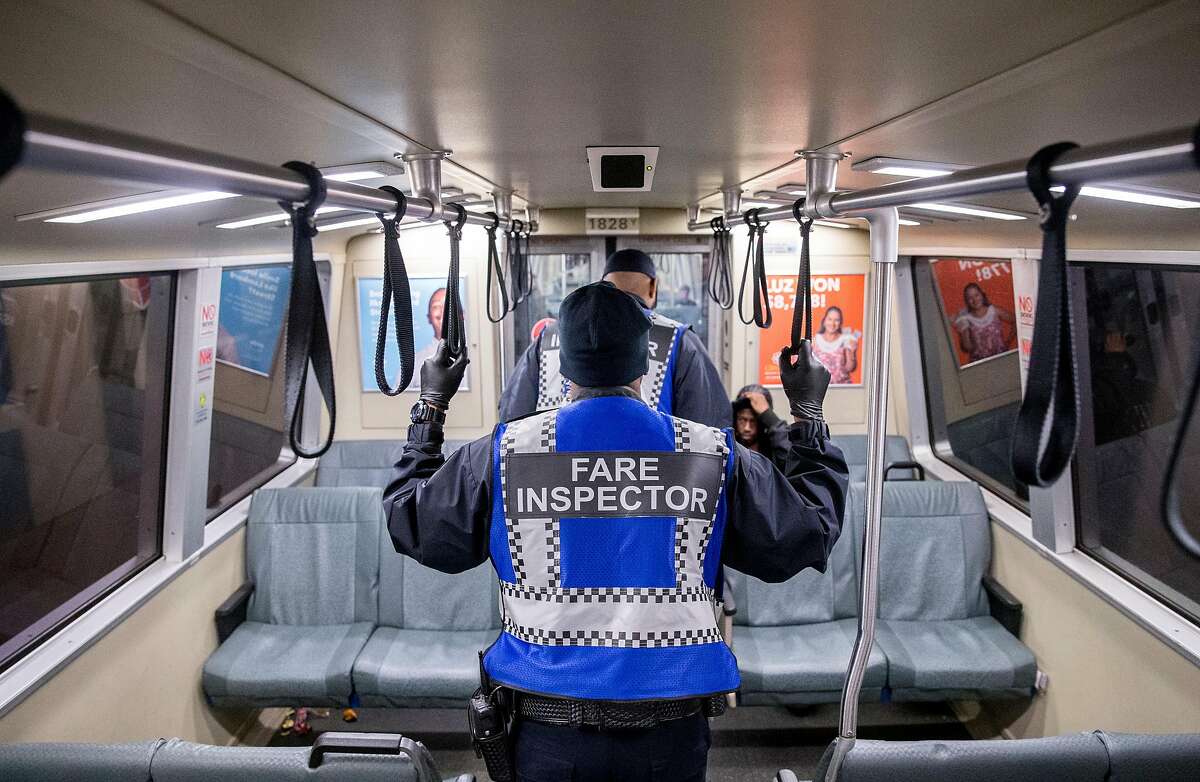 Fare Inspectors patrol a Daly City bound Bart train during the morning commute in San Francisco, Calif. Thursday, May 31, 2018.