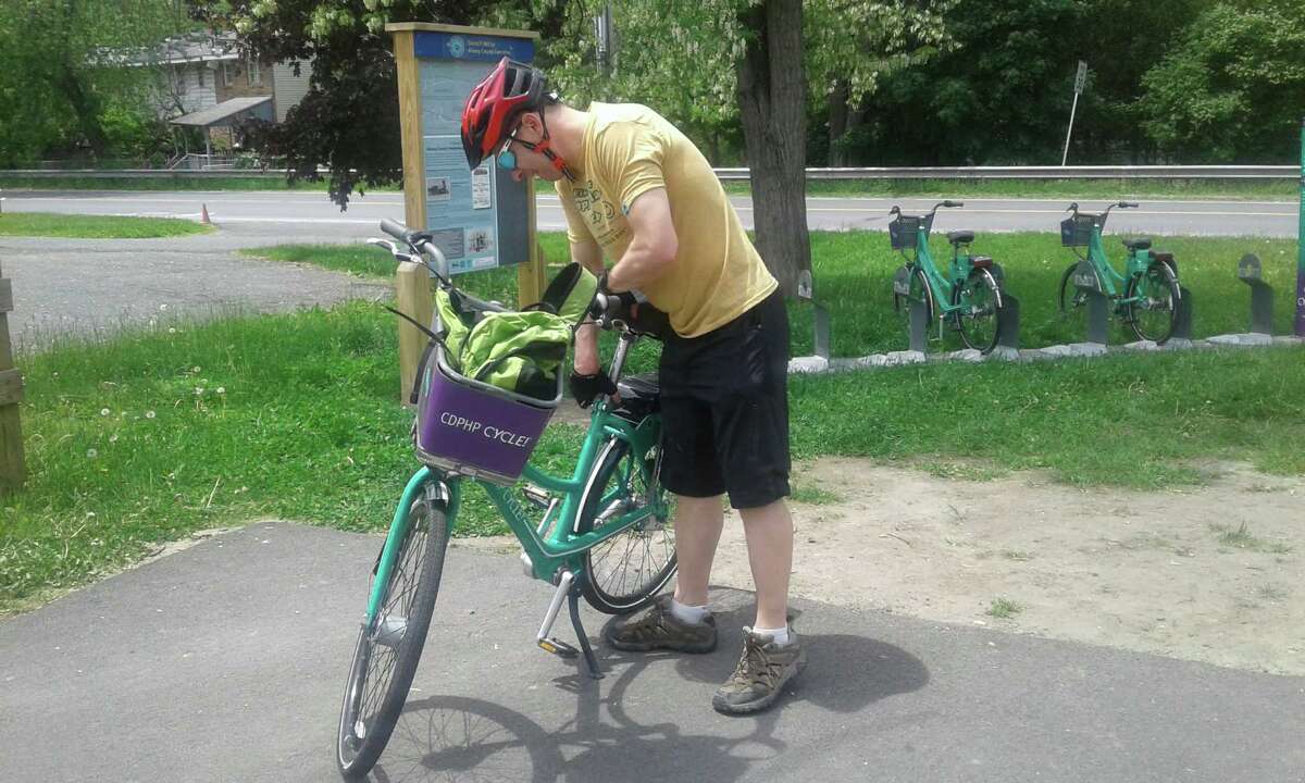 Herb Terns checks on a bike from the CDPHP Cycle! program. (Gillian Scott / Special to the Times Union)