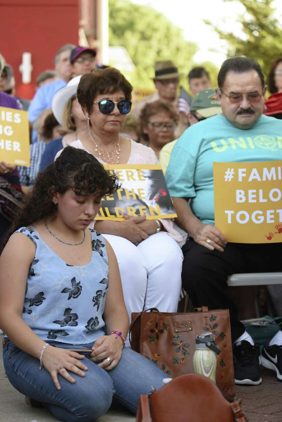 People pray during a rally in support of immigrant children and families, led by U.S. Rep. Joaquin Castro, the Texas Organizing Project, MALC, RAICES and other groups, at the Guadalupe Cultural Center on Thursday, May 31, 2018.