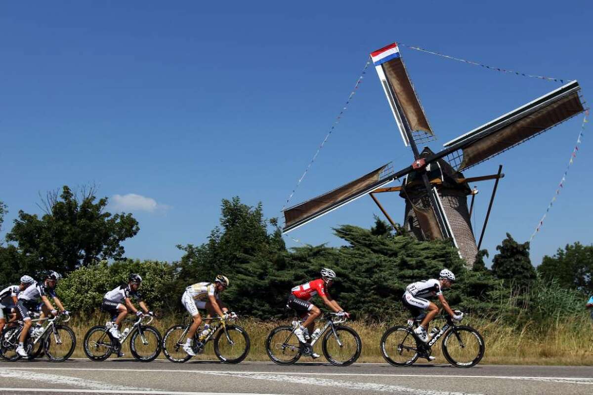 ROTTERDAM, NETHERLANDS - JULY 04: The peloton passes a windmill during stage one of the 2010 Tour de France from Rotterdam to Brussels on July 4, 2010 in Rotterdam, Netherlands. (Photo by Bryn Lennon/Getty Images)