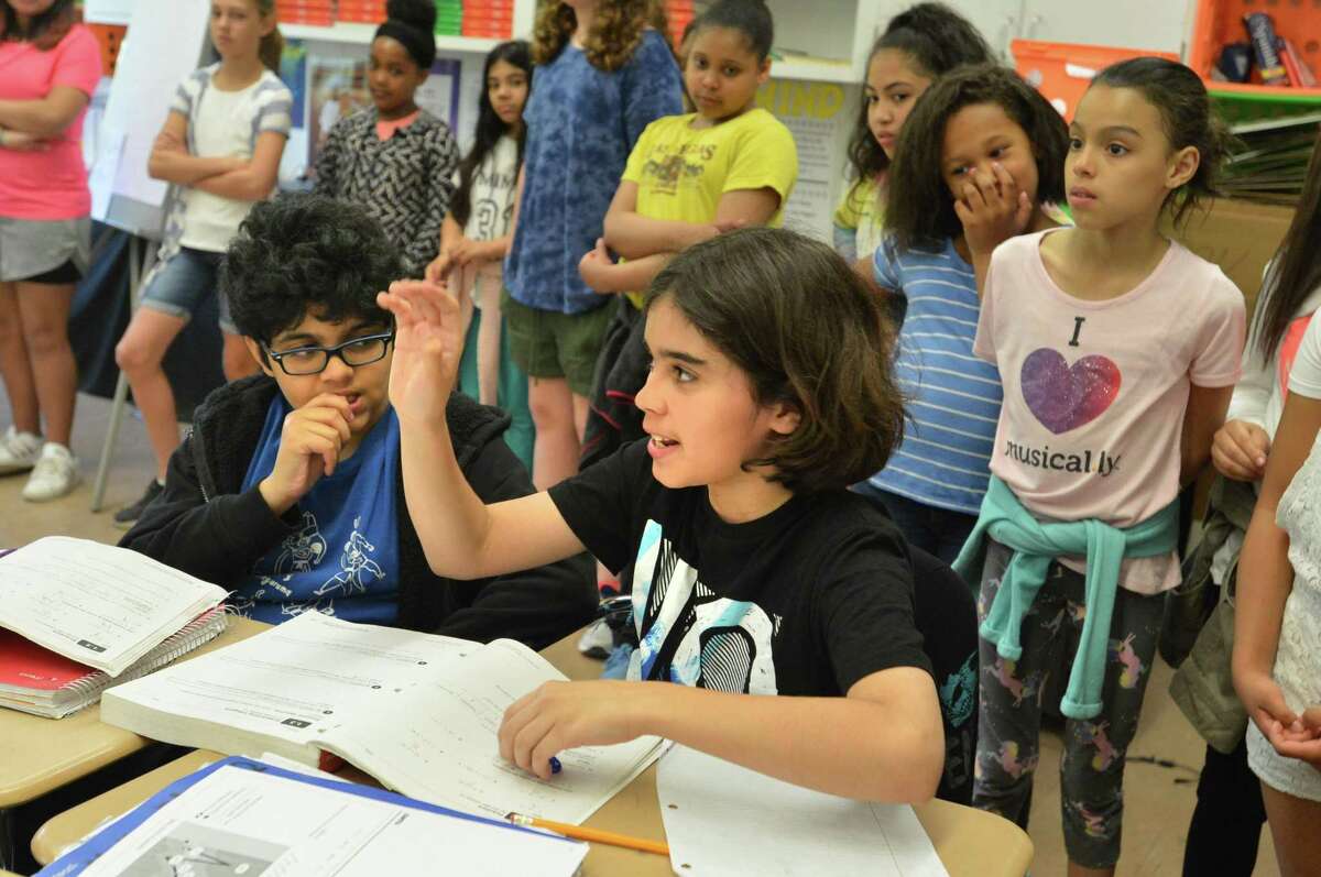 6th-grader Anthony Certo answers a question about his school while Guidance Counselor Kathy Mahoney takes a group of 5th grade students from Rowayton Elementary School on a tour of Roton Middle School where they will be going next year on Monday May 21, 2018 in Norwalk Conn.