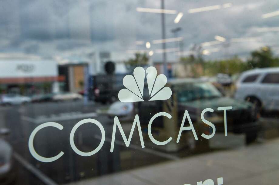 Signage Is Displayed In The Window Of A Comcast Corp Xfinity King