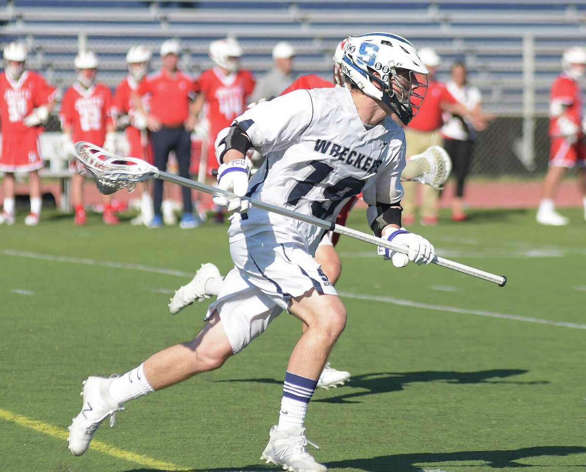 Staples senior long pole middie Brandon Adrian races up the field with the ball during Wednesday’s game against Fairfield Prep.