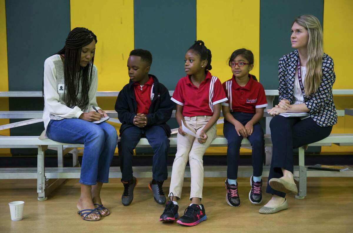 Houston Chronicle reporter erooke Lewis interviews a trio of first graders during a tour of the Harmony Science Academy of Sugar Land.
