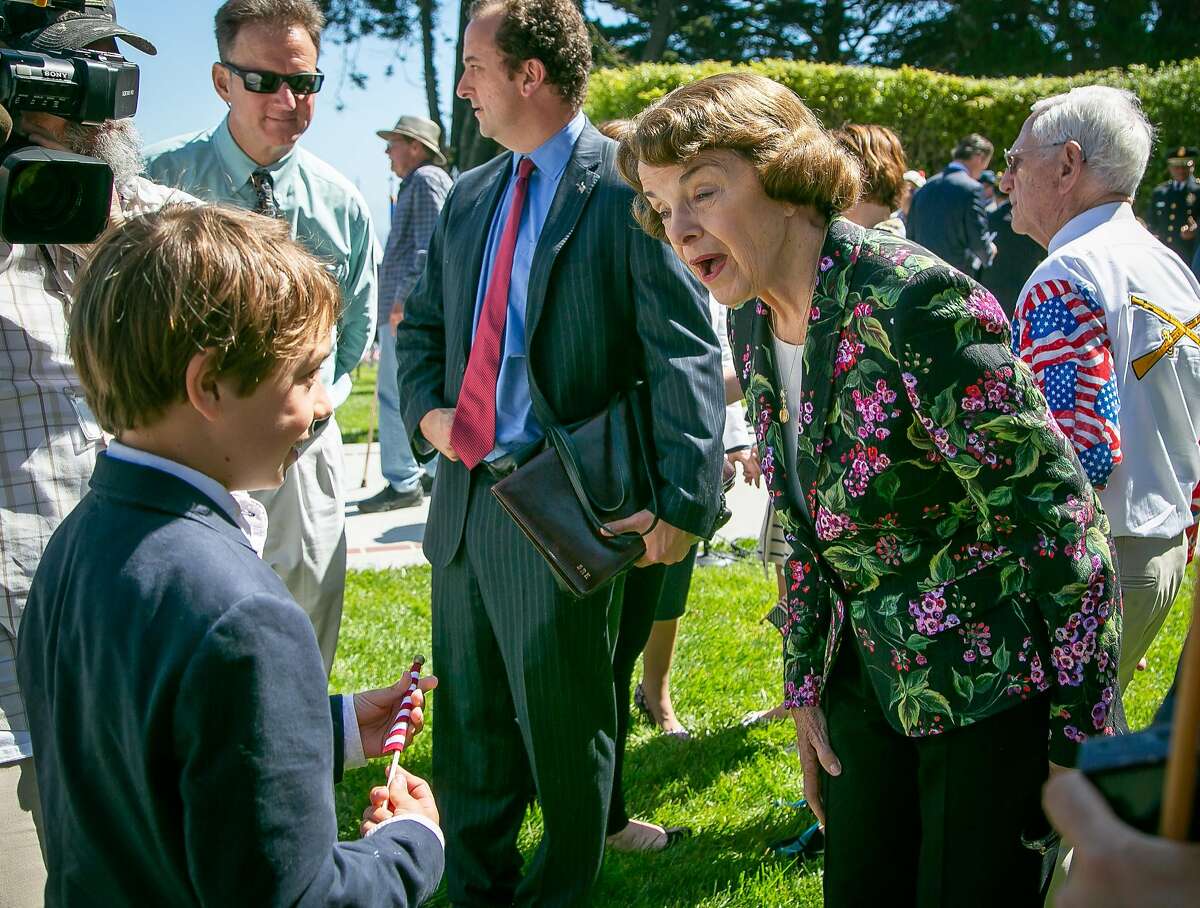 Sen. Dianne Feinstein, who leads all polls on the U.S. Senate race, chats with a boy at the Presidio on Memorial Day.
