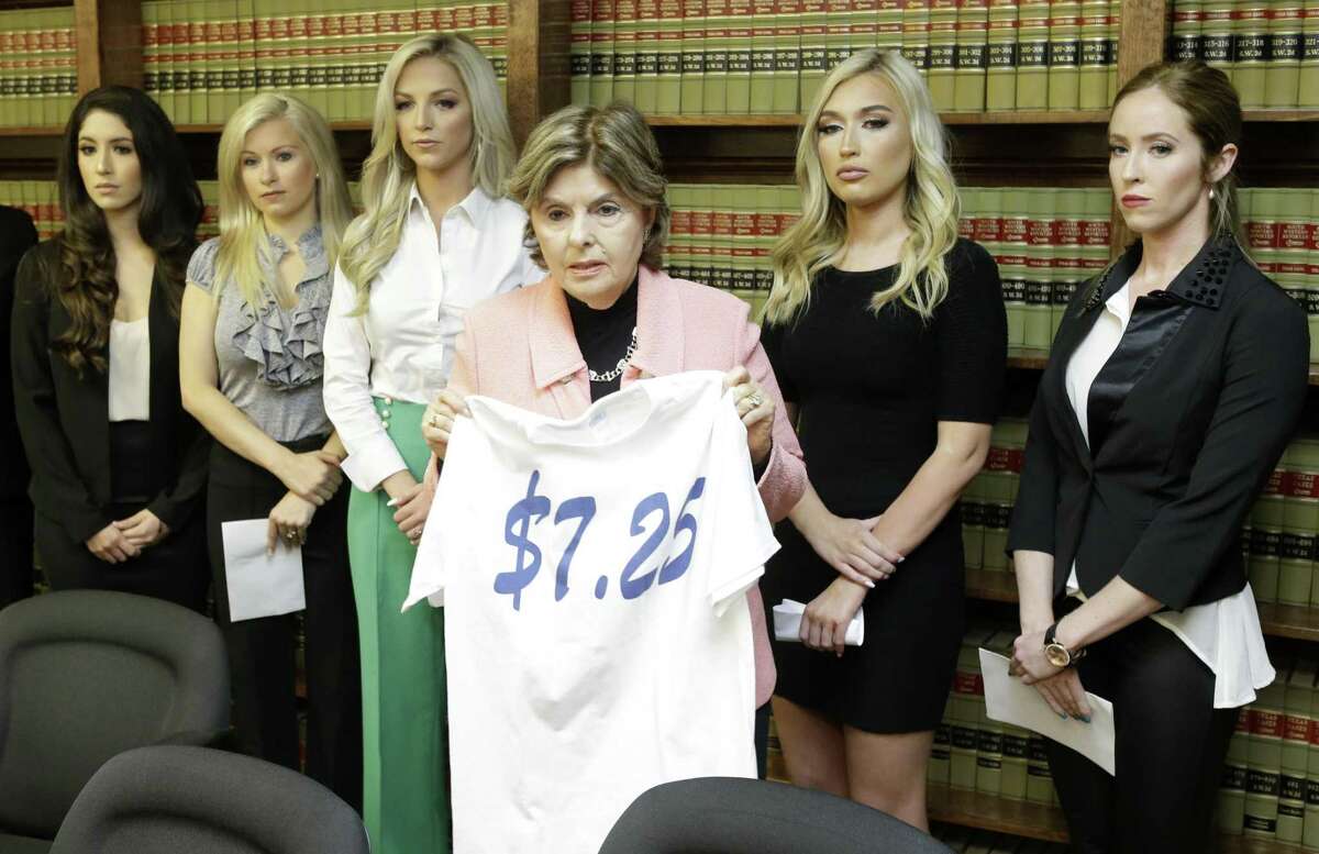 Attorney Gloria Allred stands among former Houston Texans cheerleaders Ashley Rodriguez, left, Morgan Wiederhold, Kelly Neuner, Hannah Turnbow, and Ainsley Parish, right, holding up a shirt printed with $7.25, the amount she says the former cheerleaders where paid per hour, as she speaks during a press conference announcing a lawsuit on behalf of the five the former cheerleaders shown at the law offices of Kimberley Spurlock, 17280 West Lake Houston Parkway, in Humble, Friday, June 1, 2018. ( Melissa Phillip / Houston Chronicle )