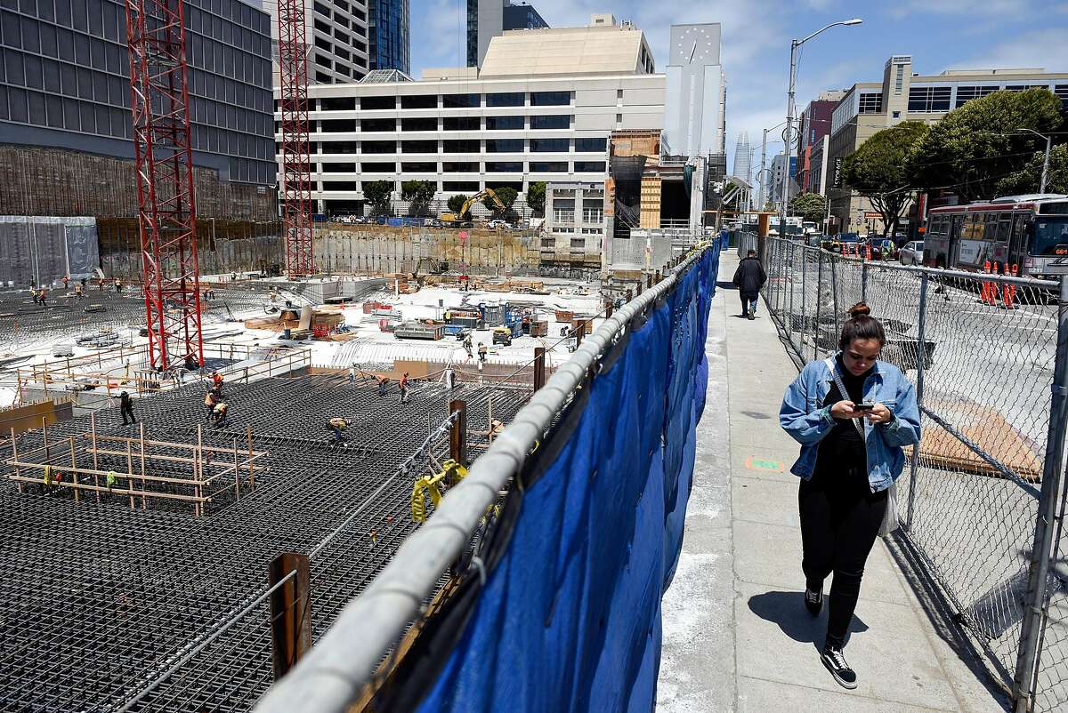 Pedestrians pass by ongoing work at a construction site on Mission and Van Ness Street in San Francisco, Calif., on Thursday May 31, 2018.