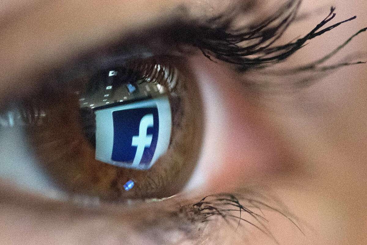 This file illustration photo taken on March 22, 2018 in Paris shows a close-up of the Facebook logo in the eye of a person posing while she looks at a flipped logo of Facebook. / AFP PHOTO / Christophe SIMONCHRISTOPHE SIMON/AFP/Getty Images