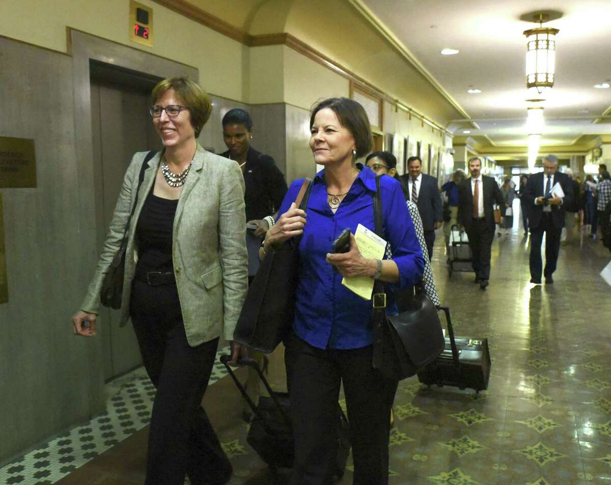Shelley Potter, right, president of the SAISD teachers union, walks with attorney Martha Owen before a hearing at the Bexar County Courthouse last year during the union’s attempt to block the charter network Democracy Prep Public Schools from taking over Stewart Elementary School. The district is considering an array of new partnerships to run up to 10 of its schools, but none of them would require teachers to give up their SAISD contracts, one of the reasons the Stewart agreement drew protests.