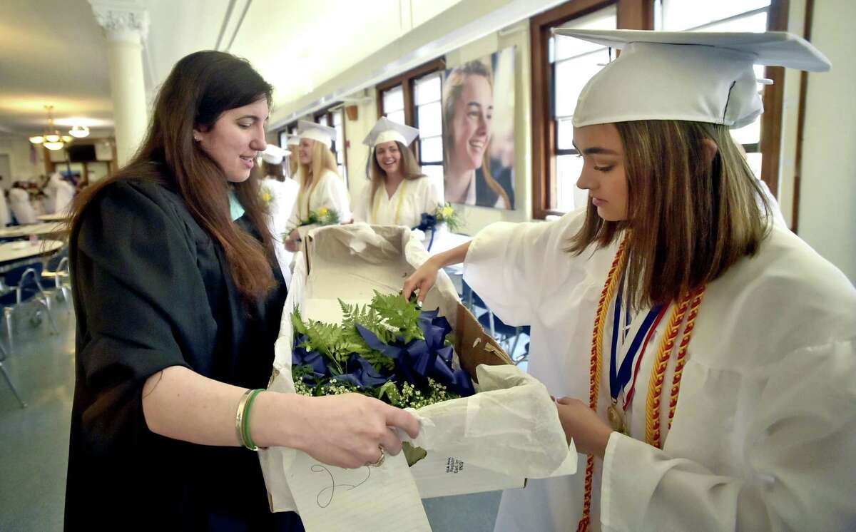 Milford, Connecticut - June 2, 2018: Lauralton Hall senior Jessica Sanchez of Milford, right, gets a rose from Dean of Student Development Jennifer Casceillo before the start of the Lauralton Hall Class of 2018 Graduation processional Saturday at Lauralton Hall in Milford.