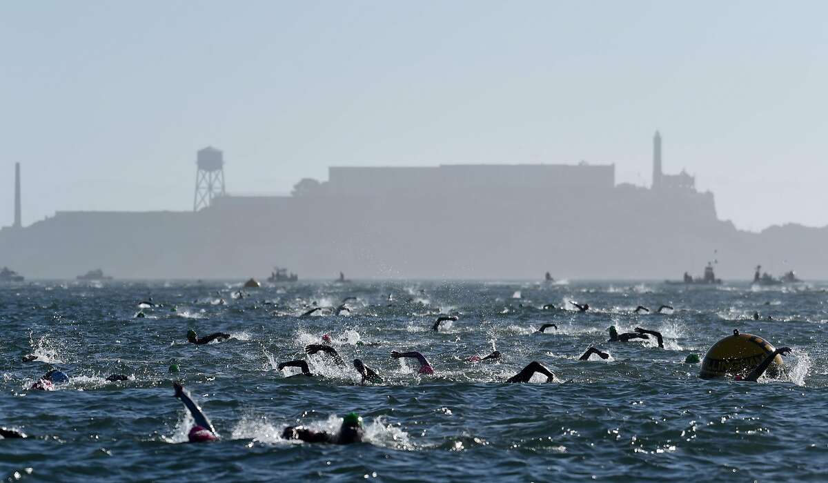 Competitors navigate the choppy waters after swimming from near Alcatraz during the swimming portion of Escape From Alcatraz Triathlon hosted in San Francisco Sunday June 3, 2018.