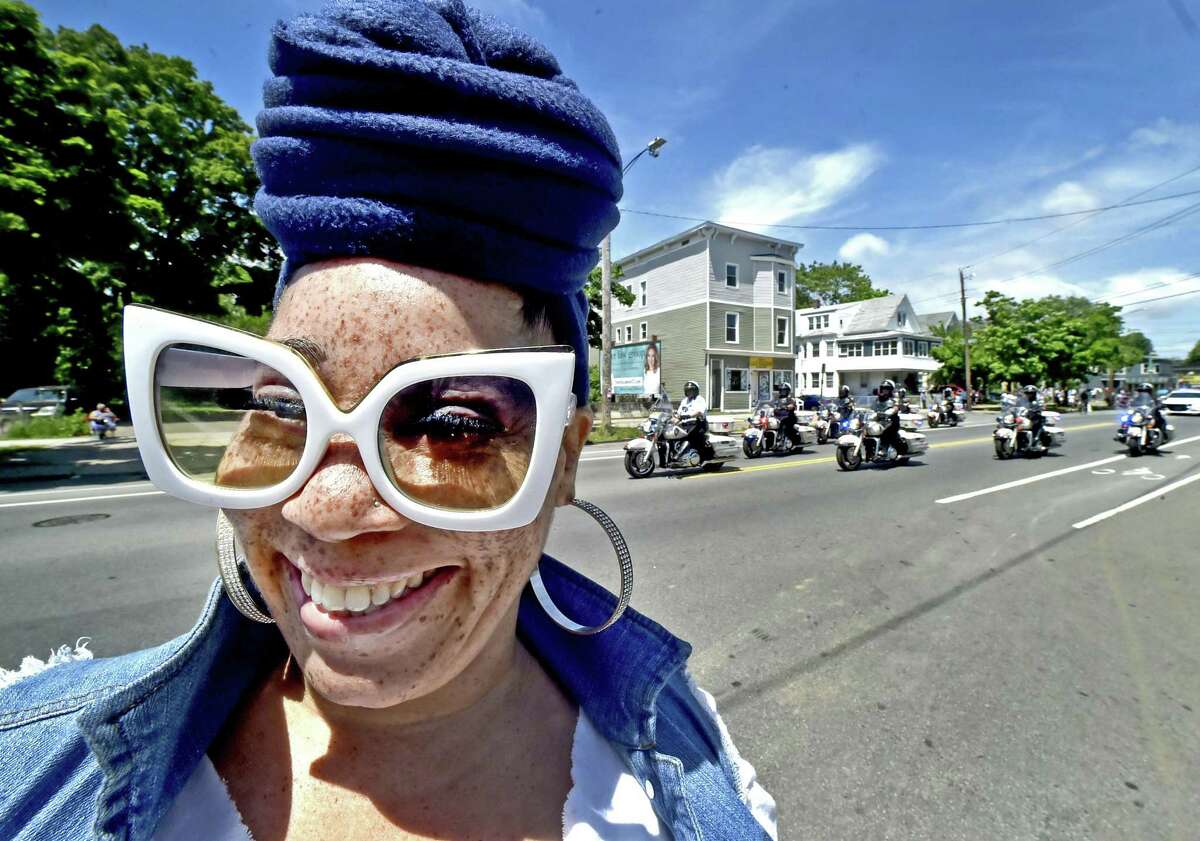 New Haven, Connecticut - June 3, 2018: Antonia Osborn of New Haven, shows of her fashionable eye glasses at the start of the Freddie Fixer parade Sunday afternoon on Dixwell Ave. in New Haven. "I have been watching the Freddie Fixer Parade all of my life and I use to march in it," she says.