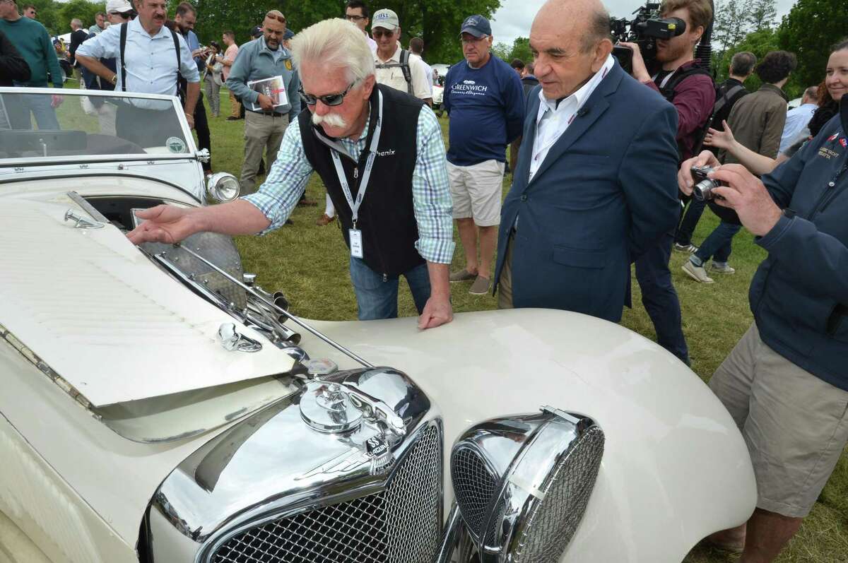 Frederick Simeone, owner of the Simeone Foundation Automotive Museum in Philadelphia Penn. talks about his vintage Jaguar with Chasing Classic Cars Television star Wayne Carini during the Greenwich Concours d'Elegance at Roger Sherman Baldwin Park in Greenwich Conn. on Sunday june 3, 2018