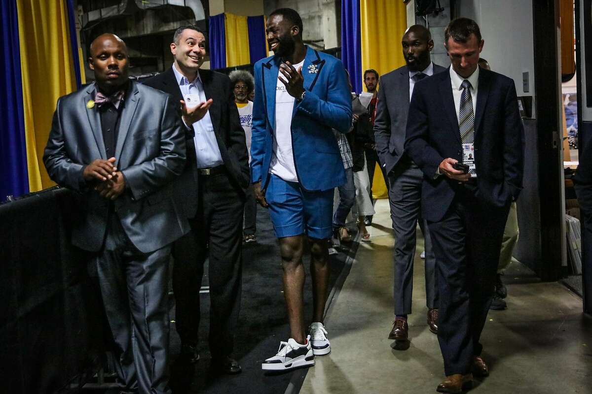 Draymond Green (23) (center) walks through Oracle Arena after Game 2 of The NBA Finals between the Golden State Warriors and the Cleveland Cavaliers in Oakland, California, on Sunday, June 3, 2018.
