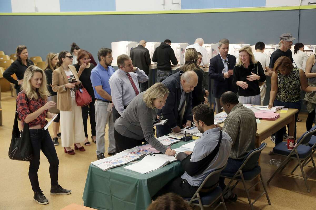 FILE- In this Nov. 8, 2016 file photo, people vote at a polling place set up at the Kenter Canyon Elementary School in Los Angeles. California's primary election on Tuesday, June 5, 2018, includes races for governor, U.S. Senate and other statewide offices, all 53 U.S. districts and most seats in the Legislature. (AP Photo/Nick Ut, File)