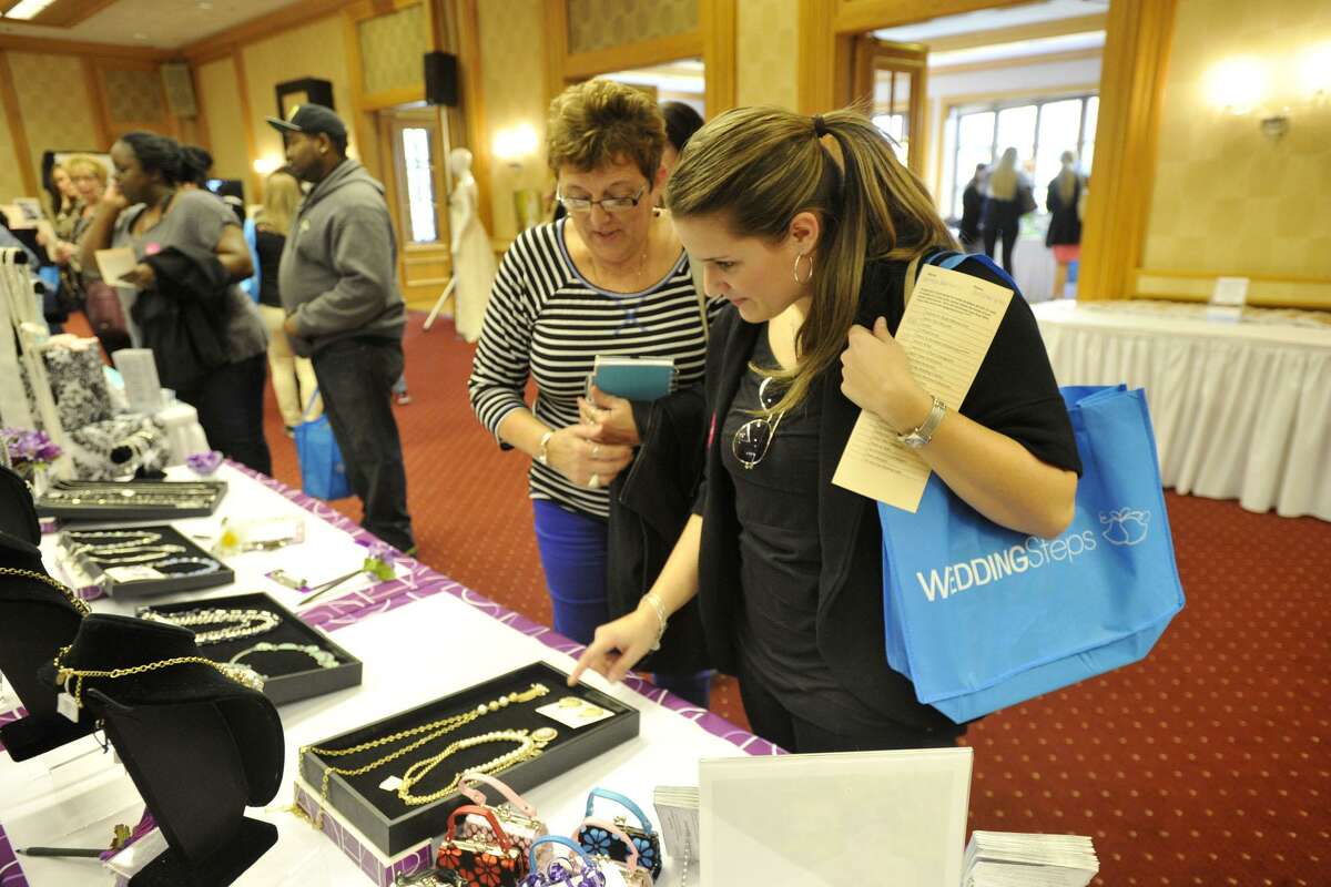Visitors peruse a booth in April 2014 at the Dolce Bridal Show at Dolce Norwalk in Norwalk, Conn.
