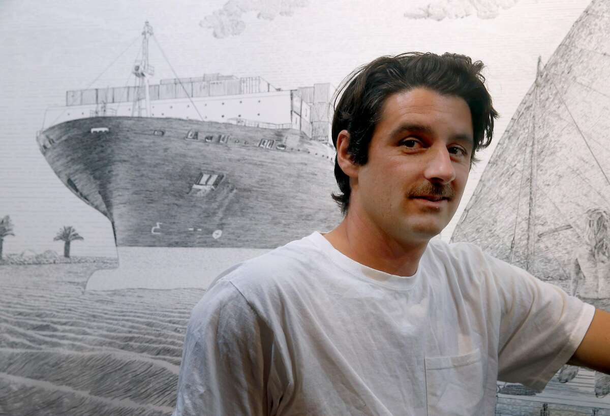 Artist Martin Machado is seen in front of an 8-foot wide ink drawing titled �The Dhow Embarking� at his studio in San Francisco, Calif. on Friday, May 18, 2018. Machado, who creates much of his artwork while at sea during his job as a merchant marine aboard container ships, will be featured in a solo show of his work at the San Francisco Art Institute's Fort Mason campus from May 30 thru Aug. 19.