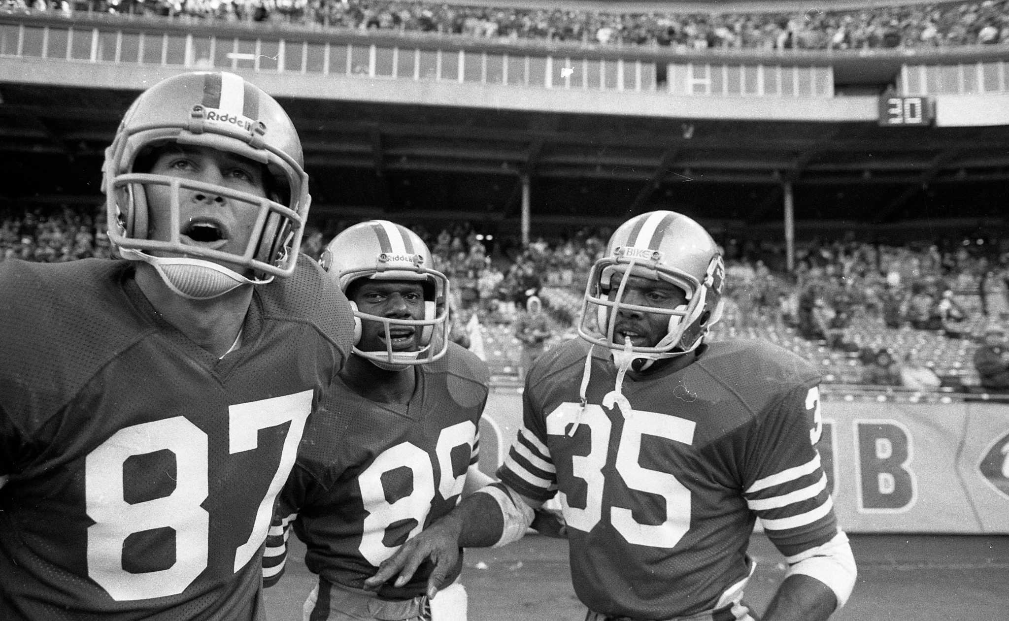 San Francisco 49ers Charlie Krueger on sidelines putting helmet