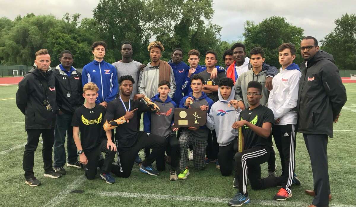 Danbury's boys track and field team poses with its 2018 State Open Championship Trophy at Willowbrook Park in New Britain Monday, June 4, 2018.