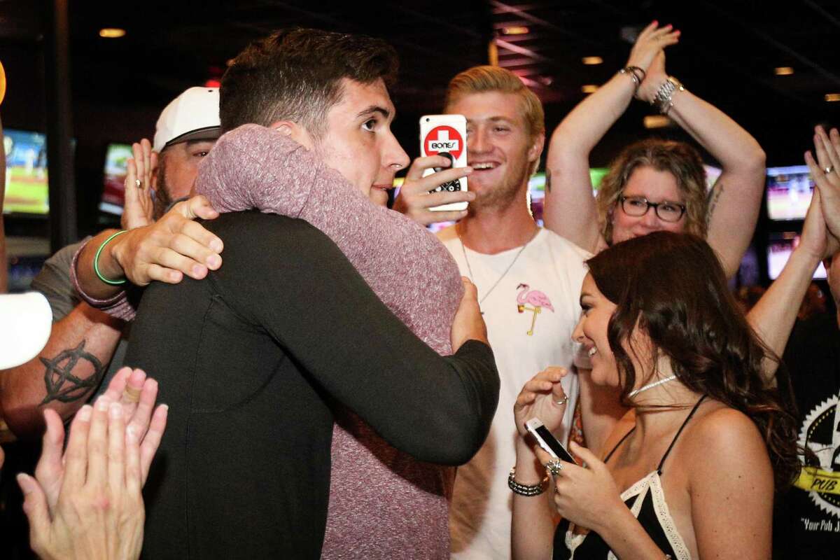 Magnolia's Jordan Groshans hugs his brother Jaxx after being drafted by the Toronto Blue Jays on Monday, June 4, 2018, at 242 Bar and Grill in Spring. (Michael Minasi / Houston Chronicle)