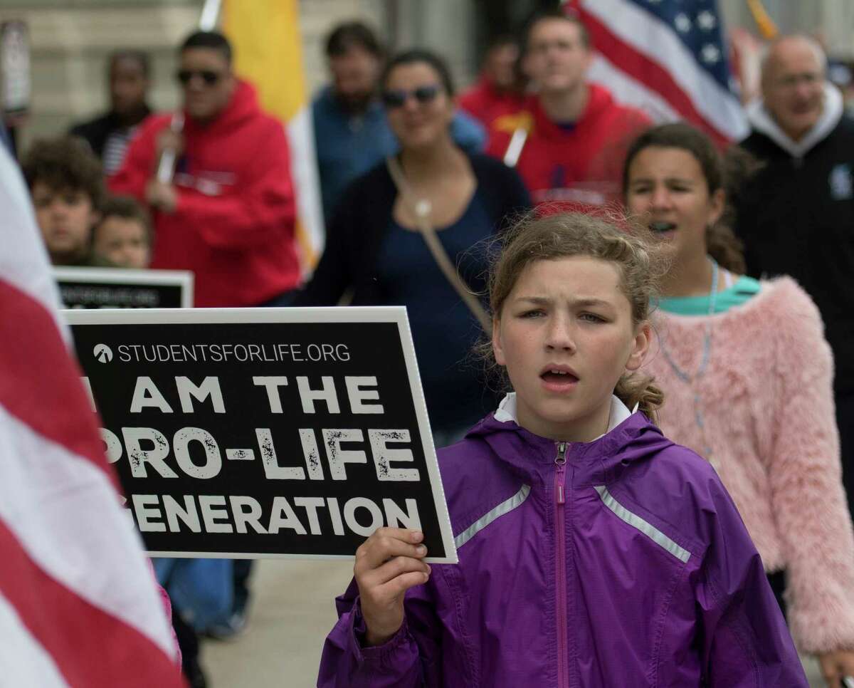 Pro life demonstrators march up State Street near the State Capitol Monday June 4, 2018, in Albany, N.Y. (Skip Dickstein/Times Union)
