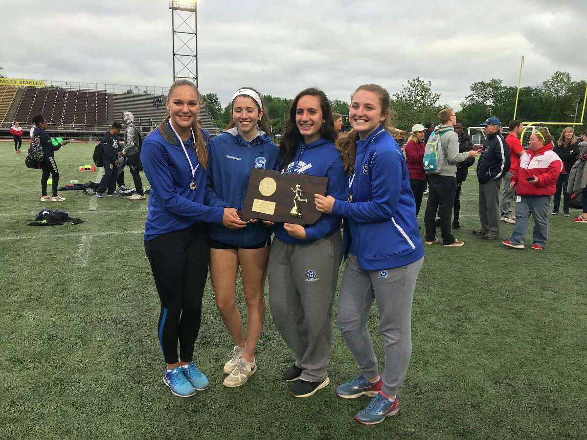 Southington's girls track captains accept the 2018 Girls State Open track and field championship Monday, June 4, 2018 at Willowbrook Park in New Britain.