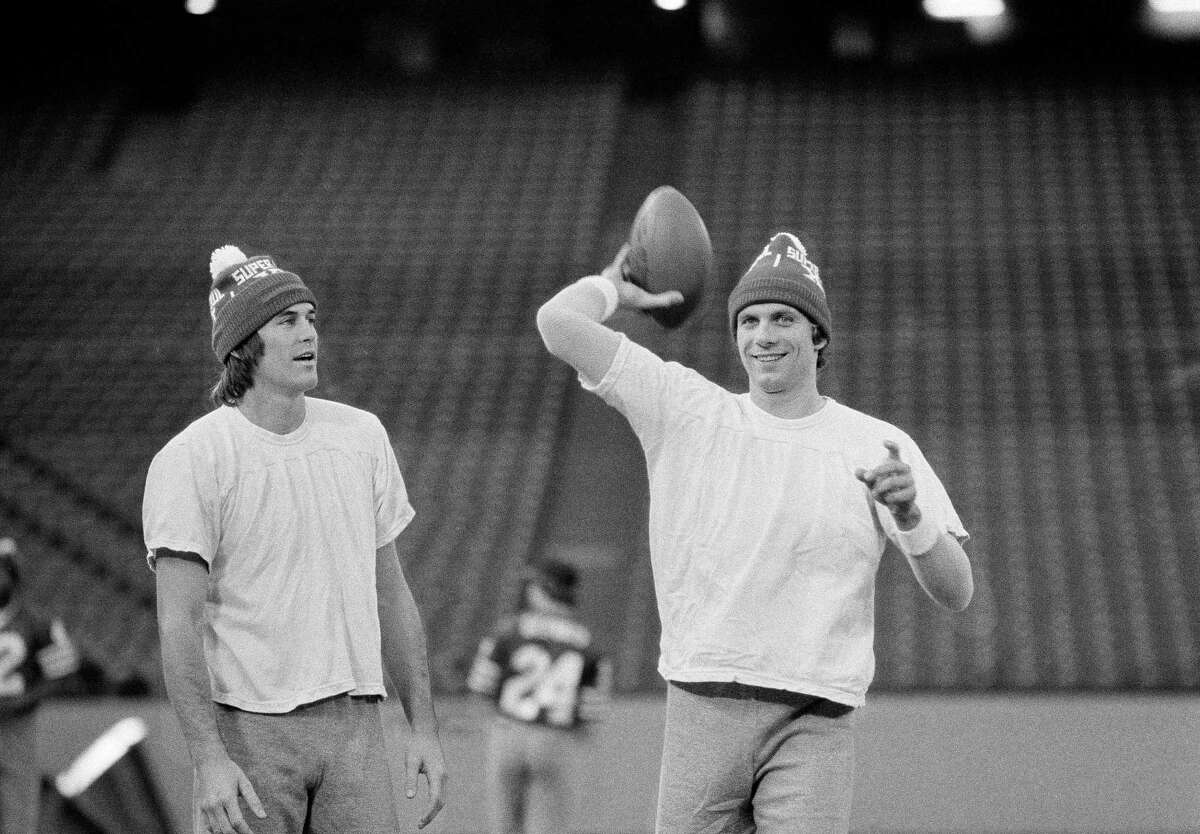 San Francisco 49ers Dwight Clark, left, and 49er quarterback Joe Montana wear their Super Bowl XVI hats as they go through a final workout in Pontiac's Silverdome, Michigan, on Saturday, Jan. 23, 1982, in preparation for Sunday's Super Bowl.