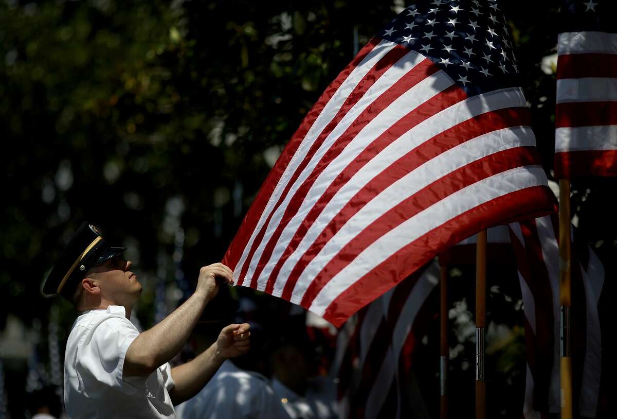 July 19 2018 - NFL and NFLPA reach agreement to put anti-protest policy on hold, but players like Kaepernick bemoan turn of discussion from racial issues to patriotism. In this photo, members of a U.S. Army honor guard team set American flags in place for a "Celebration of America" event on the south lawn of the White House June 5, 2018 in Washington, DC. The event, originally intended to honor the NFL Super Bowl champion Philadelphia Eagles, was changed after the majority of the team declined to attend the event due to a disagreement with U.S. President Donald Trump over NFL players kneeling during the national anthem.