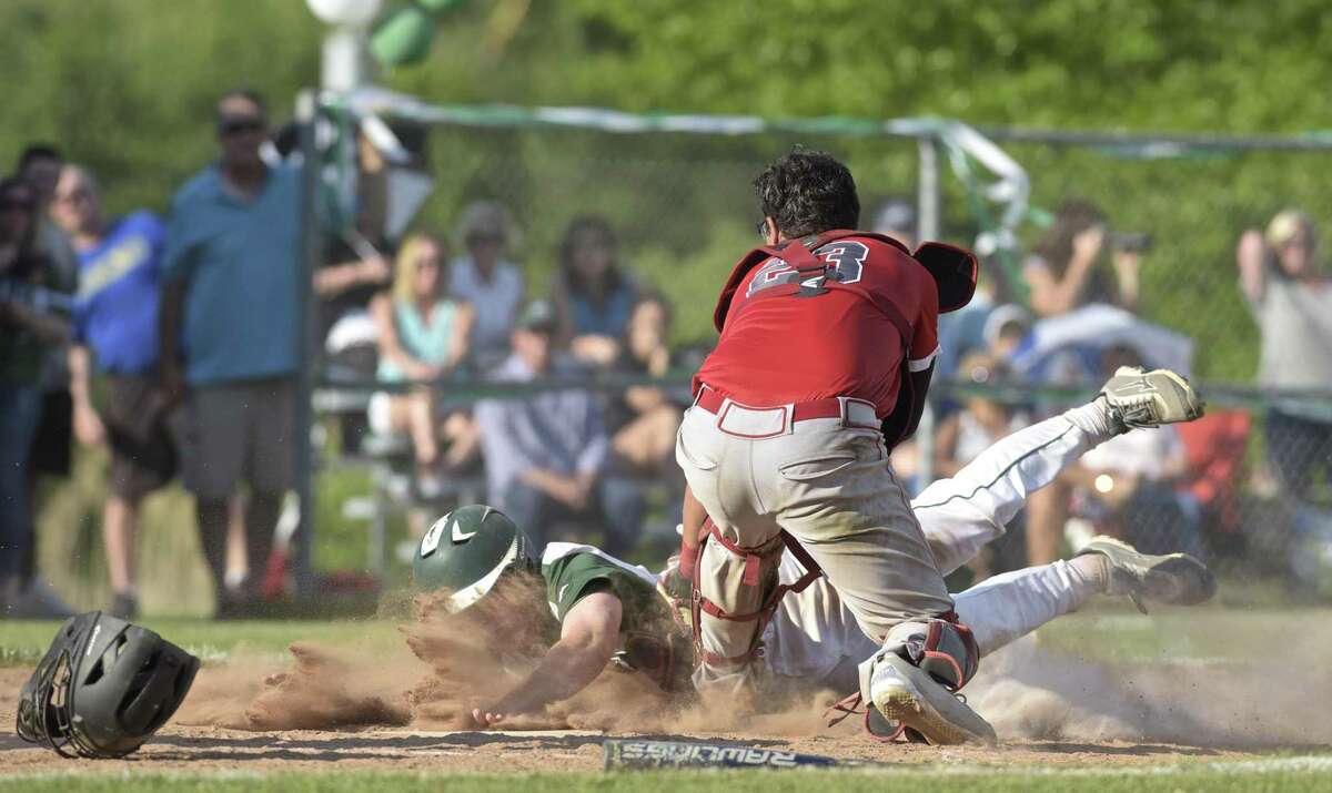Greenwich catcher Cristian Perez (23) tags out New Milford's JonLuc Dumas for the final out of the Connecticut Class LL baseball game between Greenwich and New Milford high schools. Tuesday afternoon, March 29, 2018, at New Milford High School, New Milford, Conn. Greenwich defeated New Milford 5-4.
