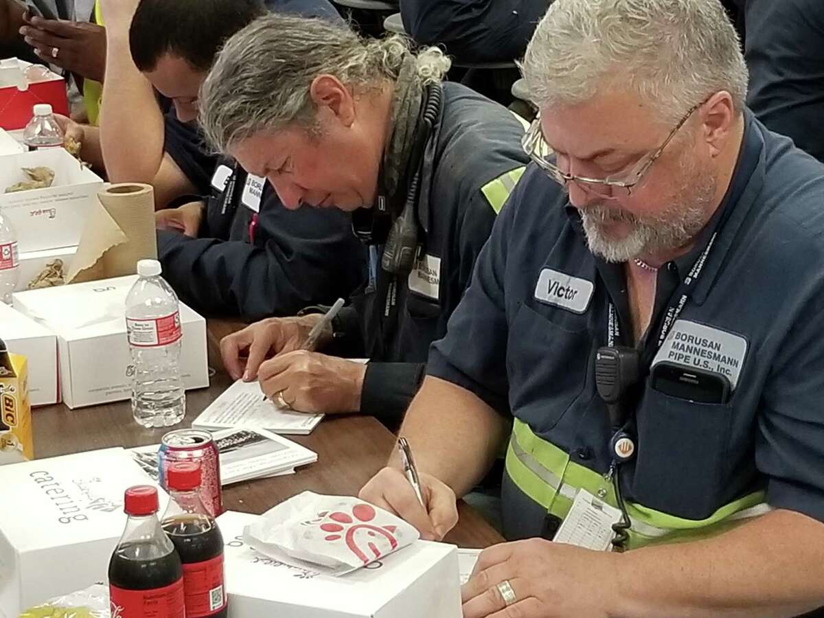 A Borusan Mannessmann Pipe employee writes one of 15 notes workers at the plant will be sending to elected officials to request a waiver for the plant on steel tariffs.