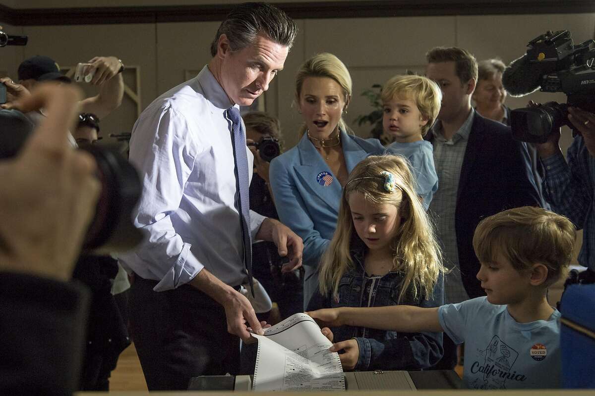 Gavin Newsom, Democratic candidate for governor of California, votes as his wife Jennifer Siebel Newsom and children watch at a polling location in Larkspur, California, U.S., on Tuesday, June 5, 2018. Democrats are facing a potentially destructive California primary vote Tuesday for an unlikely reason: too many viable candidates are running for the same U.S. House seats. Photographer: David Paul Morris/Bloomberg