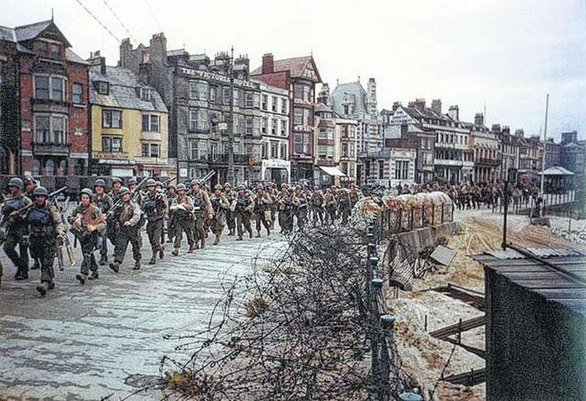 U.S. soldiers march en route to board landing ships for the invasion of France.
