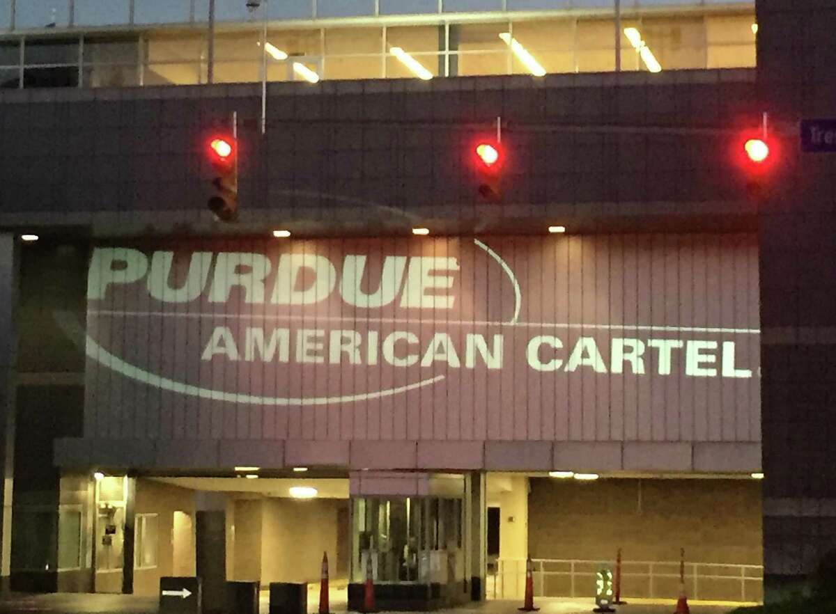 A protest on Tuesday, June 5, 2018, consisting of text projected onto Purdue Pharma’s headquarters building at 201 Tresser Blvd., in downtown Stamford, Conn., accused the company of being a “cartel.”