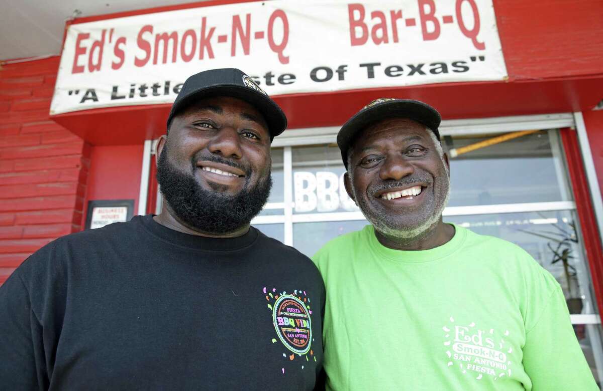 Chris Ashford stands with his father Ed Ashford in front of the elder's restaurant, Ed's Smoke-N-Q.