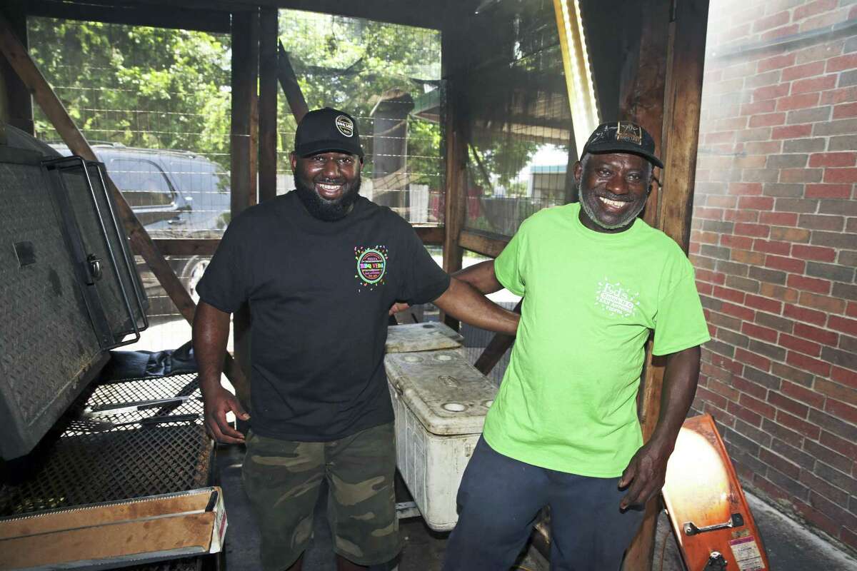 Ed Ashford (right) and his son Chris Ashford run separate barbecue restaurants on the East Side that are located within 2 miles of each other.