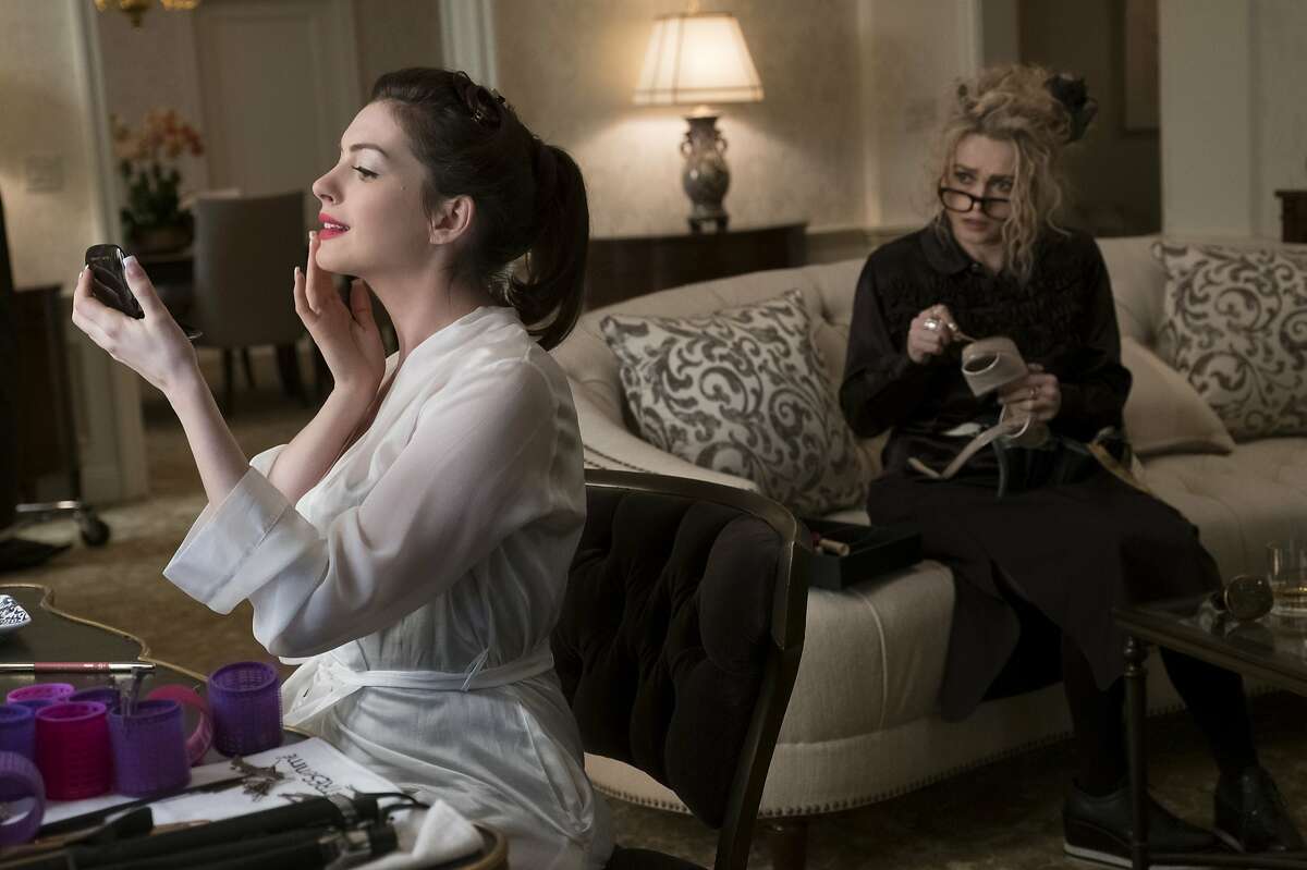 This image released by Warner Bros. shows Anne Hathaway, left, and Helena Bonham Carter in a scene from "Ocean's 8." (Barry Wetcher/Warner Bros. via AP)