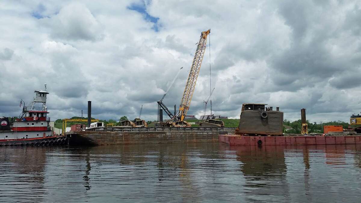 Crews lift up portions of a sunken barge from the bottom of the Hudson River at the Port of Coeymans on June 6, 2018.
