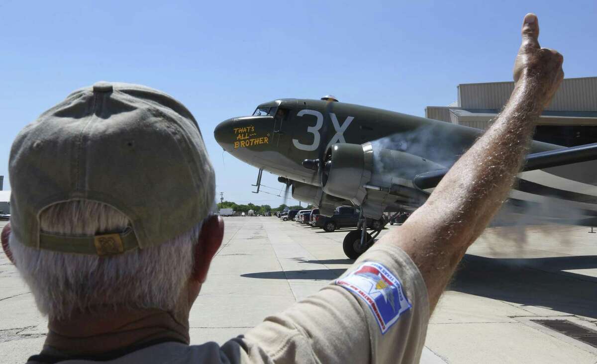 A ground crew member gives a thumbs up signal Wednesday, June 6, 2018 the pilot of the C-47 cargo plane "That's All Brother" as the aircraft taxis to the runway from the Commemorative Air Force's San Marcos facility for a flight as part of the organization's D-Day ceremonies. The recently-restored and now San Marcos-based C-47 was the lead aircraft across the English Channel on D-Day. The CAF is making plans to fly the aircraft to England in 2019 to take part in the 75th anniversary of the event.