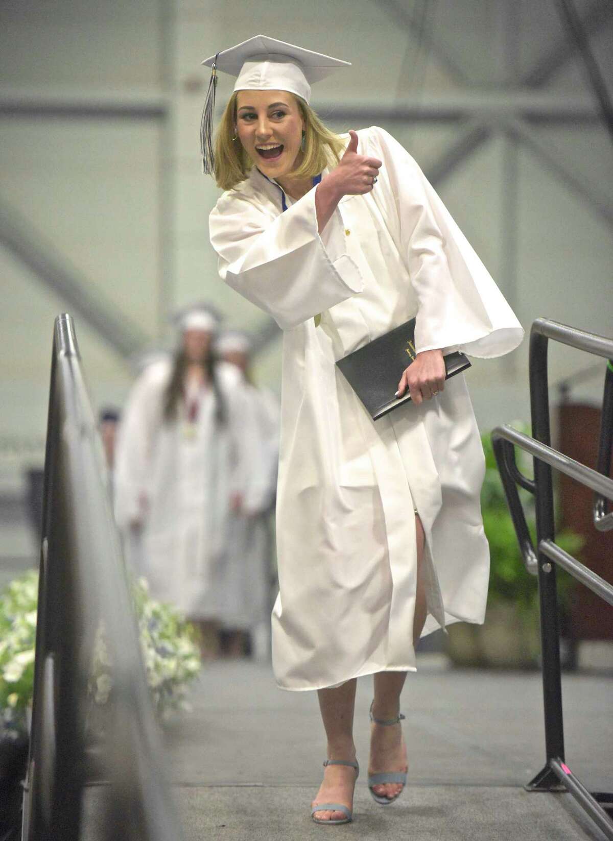 Claire Cavan Goode give the thumbs up after recieving her diploma during the 2018 Immaculate High School Commencement, Wednesday, June 6, 2018, at the O'Neill Center, Western Connecticut State University, Danbury, Conn.