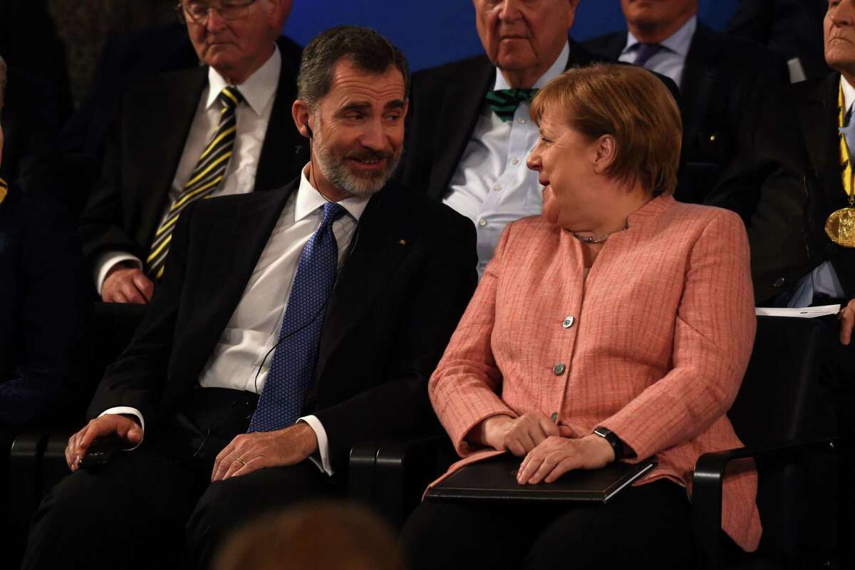 The King of Spain, Felipe VI talks with German Chancellor Angela Merkel before the Charlemagne prize award ceremony on May 10, 2018 in Aachen, western Germany. French President Emmanuel Macron will receive the prestigious Charlemagne Prize for his "contagious enthusiasm" for strengthening EU cohesion and integration. / AFP PHOTO / PATRIK STOLLARZPATRIK STOLLARZ/AFP/Getty Images